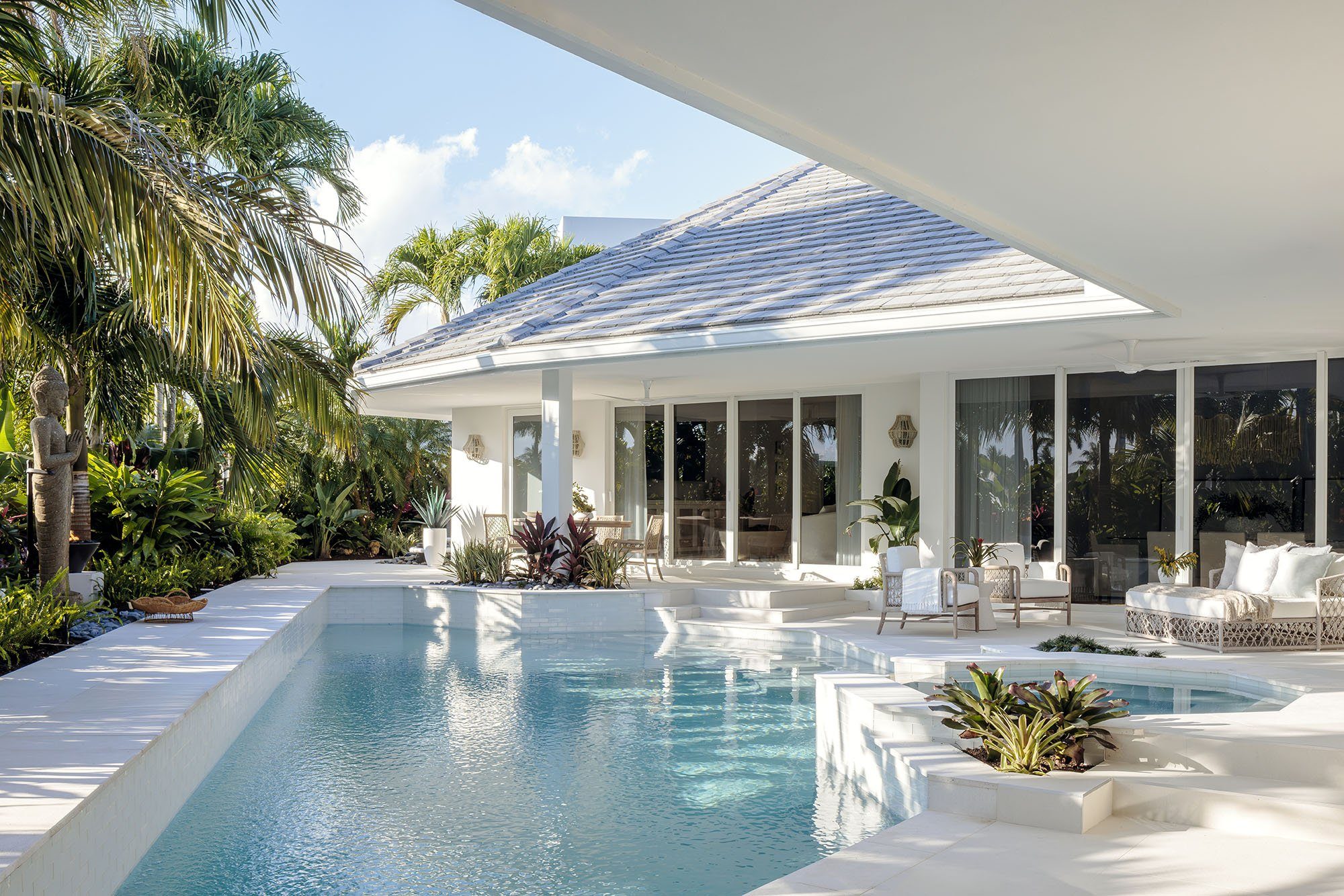 Sunlit pool and modern pool house at a Boca Raton estate designed by CasaRio Design